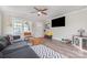 Bright living room with a gray sectional sofa, wood floors, and large windows for natural light at 3965 Hemingway Dr, Hickory, NC 28601