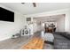 Open-concept living room with a large gray sectional sofa, wood floors, and an open view of the kitchen at 3965 Hemingway Dr, Hickory, NC 28601