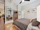Cozy bedroom with hardwood floors, dresser, and large mirror to reflect natural light at 404 N Laurel Ave # 11, Charlotte, NC 28204