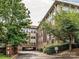 Condo exterior features brick accents, drive-under parking, and mature landscaping at 404 N Laurel Ave # 11, Charlotte, NC 28204