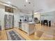 Bright open concept kitchen with island, stainless appliances, and hardwood floors at 404 N Laurel Ave # 11, Charlotte, NC 28204