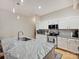 Bright kitchen featuring a granite island and white cabinets at 404 N Laurel Ave # 11, Charlotte, NC 28204