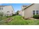 Large backyard featuring well-maintained lawn, garden beds, and privacy fencing at 424 Paperbark Ln, Rock Hill, SC 29732
