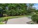 Landscaped backyard with a concrete patio, providing a serene outdoor space with mature trees at 424 Paperbark Ln, Rock Hill, SC 29732
