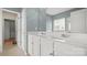 Bright primary bathroom features double sinks with white cabinetry and a large vanity mirror at 424 Paperbark Ln, Rock Hill, SC 29732