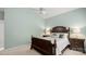 Cozy bedroom with a wooden bed frame, soft lighting, and neutral-colored carpet at 424 Paperbark Ln, Rock Hill, SC 29732