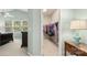 Bedroom featuring a peek into a walk-in closet, plus a table lamp and a glimpse of the bed at 424 Paperbark Ln, Rock Hill, SC 29732