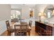 Classic dining room featuring wooden table and chairs, lamps, and open access to living spaces at 424 Paperbark Ln, Rock Hill, SC 29732