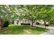 Exterior shot of property with well-kept lawn, blooming trees, and two-car garage at 424 Paperbark Ln, Rock Hill, SC 29732