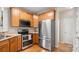 Modern kitchen showcasing stainless steel appliances and wood cabinetry at 424 Paperbark Ln, Rock Hill, SC 29732