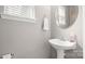 Elegant powder room with a stylish pedestal sink and neutral decor at 424 Paperbark Ln, Rock Hill, SC 29732