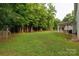 Large, well-maintained backyard with lush green grass, mature trees, and an outdoor playset at 481 Evergreen Rd, Clover, SC 29710