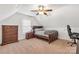 Attic bedroom featuring a bed, ceiling fan, window, and furniture at 481 Evergreen Rd, Clover, SC 29710