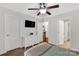 Neutral-toned bedroom with ceiling fan, TV, and two entrances at 481 Evergreen Rd, Clover, SC 29710