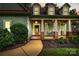 Inviting front porch with classic columns, hanging plants, and a cozy seating area for relaxing outdoors at 481 Evergreen Rd, Clover, SC 29710