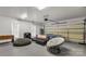 Spacious game room with ping pong table, foosball table, comfortable seating, and garage door access at 481 Evergreen Rd, Clover, SC 29710