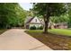 View of a single-Gathering home with side-entry garage and extended driveway, plus lush landscaping at 481 Evergreen Rd, Clover, SC 29710