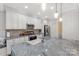 Kitchen island featuring granite countertop, stainless appliances, and white cabinets at 481 Evergreen Rd, Clover, SC 29710