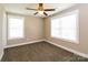 Cozy bedroom with plush carpet, natural light from the windows, and a ceiling fan at 515 Kings Mountain St, Clover, SC 29710