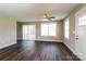 Bright living room features hardwood floors, a ceiling fan, and access to the deck at 515 Kings Mountain St, Clover, SC 29710