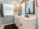 Well-lit bathroom with double vanity and modern fixtures at 5432 Kinsbridge Dr, Charlotte, NC 28227
