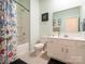 Light-filled bathroom featuring a shower-tub and a modern vanity at 5432 Kinsbridge Dr, Charlotte, NC 28227