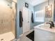 Bright bathroom featuring a tiled walk-in shower and double vanity at 5432 Kinsbridge Dr, Charlotte, NC 28227