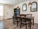 A stylish dining room with a dark table and chairs, decorative mirrors, and modern lighting at 5432 Kinsbridge Dr, Charlotte, NC 28227