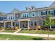Charming townhome with a brick facade, inviting porch, and beautifully landscaped front yard at 5432 Kinsbridge Dr, Charlotte, NC 28227