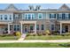 Charming brick townhome with inviting front porch and well-maintained landscaping at 5432 Kinsbridge Dr, Charlotte, NC 28227
