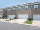 Rear exterior view of garages with white doors and well-maintained landscaping at 5432 Kinsbridge Dr, Charlotte, NC 28227