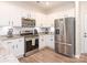 Modern kitchen featuring stainless steel appliances, granite countertops, and ample white cabinetry at 5432 Kinsbridge Dr, Charlotte, NC 28227