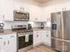 Modern kitchen featuring stainless steel appliances and white cabinetry at 5432 Kinsbridge Dr, Charlotte, NC 28227