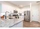 Modern kitchen with white cabinets, stainless steel appliances, granite countertops, and hardwood floors at 5432 Kinsbridge Dr, Charlotte, NC 28227