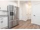 View of the kitchen features a stainless steel refrigerator and pantry access at 5432 Kinsbridge Dr, Charlotte, NC 28227