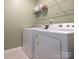 Practical laundry room with a side-by-side washer and dryer and upper shelf at 5432 Kinsbridge Dr, Charlotte, NC 28227
