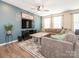 Comfortable living room with a plush sectional sofa, modern decor, and a large TV at 5432 Kinsbridge Dr, Charlotte, NC 28227