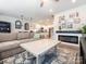 Inviting living room with fireplace that opens to a bright, white kitchen at 5432 Kinsbridge Dr, Charlotte, NC 28227