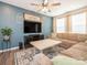 Comfortable living room with large TV, modern ceiling fan, and decorative accents at 5432 Kinsbridge Dr, Charlotte, NC 28227