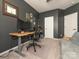 Study room with a modern adjustable desk, and two computer monitors at 5432 Kinsbridge Dr, Charlotte, NC 28227