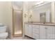 Bathroom featuring double sink vanity, shower, and ample cabinet space for convenient storage at 5601 Fairview Rd # 11, Charlotte, NC 28209