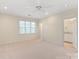 Spacious bedroom with neutral carpet, ceiling fan, and an en suite bathroom for ultimate comfort at 5601 Fairview Rd # 11, Charlotte, NC 28209