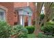 Charming brick building entrance featuring white columns and mature landscaping at 5601 Fairview Rd # 11, Charlotte, NC 28209