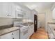 Well-maintained kitchen with granite counters, white appliances, and plenty of cabinets at 5601 Fairview Rd # 11, Charlotte, NC 28209