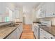Bright kitchen featuring granite counters, and white appliances at 5601 Fairview Rd # 11, Charlotte, NC 28209