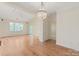 Spacious living room with hardwood floors, a chandelier, and natural light at 5601 Fairview Rd # 11, Charlotte, NC 28209