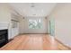 Bright living room with hardwood floors, fireplace, built-in shelving and large windows offering a view at 5601 Fairview Rd # 11, Charlotte, NC 28209