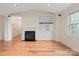 Bright living room with hardwood floors, fireplace, and built-in shelving at 5601 Fairview Rd # 11, Charlotte, NC 28209