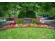 Community entrance sign with brick pillars and colorful flower bed landscaping at 5601 Fairview Rd # 11, Charlotte, NC 28209
