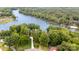 Aerial view of the property showcasing the beautiful lake and surrounding mature trees at 6719 Love Point Rd, Denver, NC 28037
